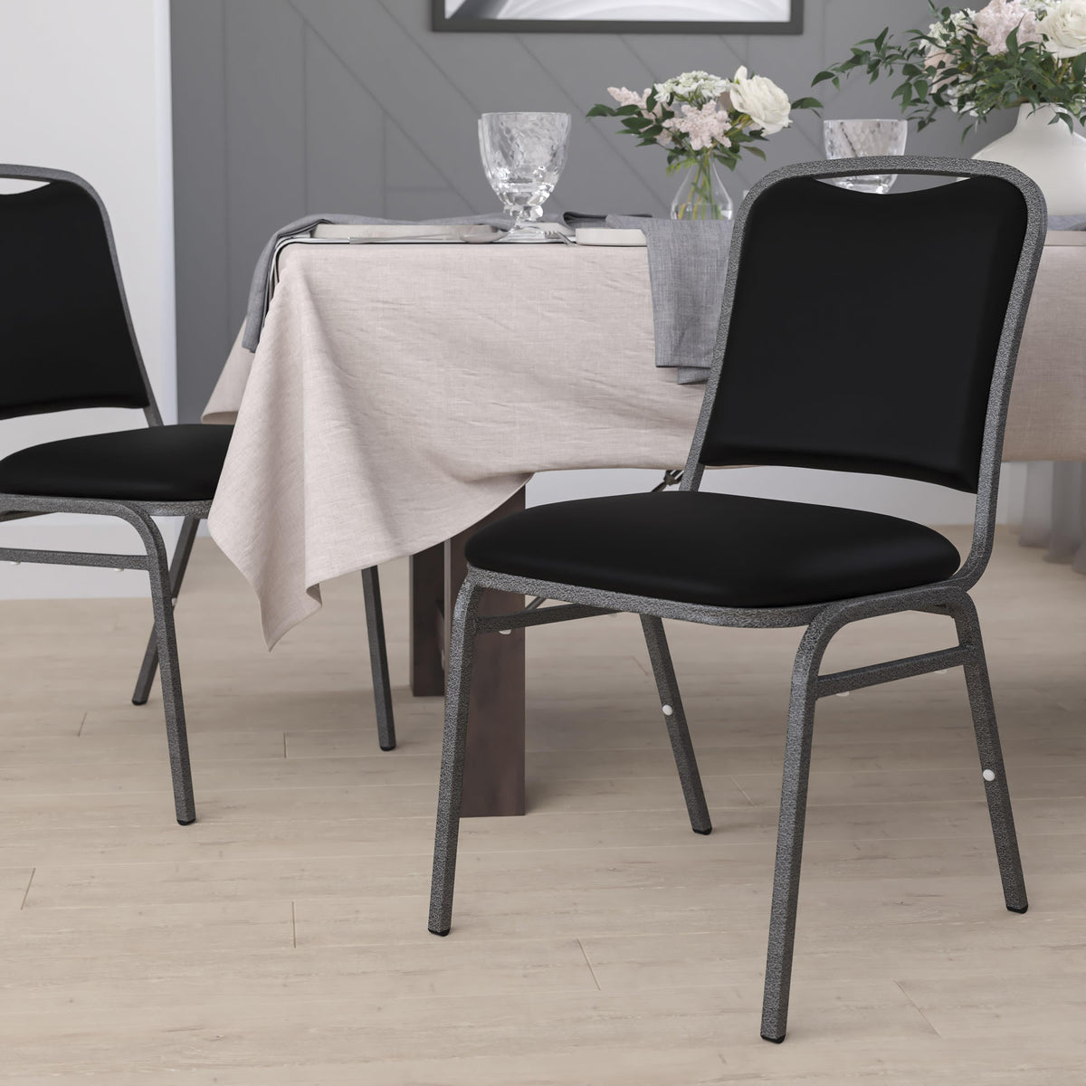 Angled Back Stacking Banquet Chair in Black Vinyl with Silver Vein Frame